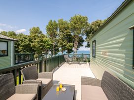 An outdoor deck with seating and a view at St Andrews Holiday Park - Holiday Accommodation 2944 St Andrews