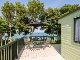 An outdoor seating area with chairs and a table at St Andrews Holiday Park - Holiday Accommodation 2944, St Andrews