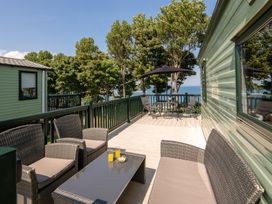A deck area with seating and a table at St Andrews Holiday Park - Holiday Accommodation 2944, St Andrews