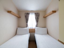 A bedroom with two beds and a window at St Andrews Holiday Park - Holiday Accommodation 2944, St Andrews
