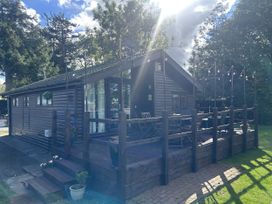 An outdoor deck with chairs and table at Haggerston Castle - Holiday Accommodation 3441 Berwick-upon-Tweed