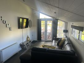 A living room with a sofa and television at Haggerston Castle - Holiday Accommodation 3441 Berwick-upon-Tweed