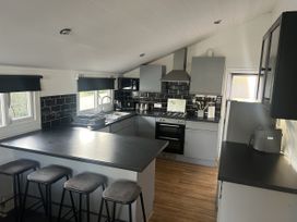 A kitchen with a sink and stove at Haggerston Castle - Holiday Accommodation 3441 Berwick-upon-Tweed