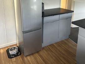 A kitchen with a refrigerator, cabinets and a pet bowl at Haggerston Castle - Holiday Accommodation 3441 Berwick-upon-Tweed
