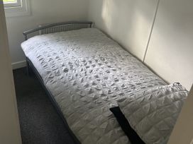 A bedroom with a bed and a window at Haggerston Castle - Holiday Accommodation 3441, Berwick-upon-Tweed