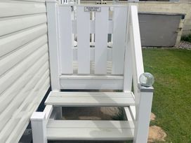 An outdoor staircase leading to a gate at Happy Days Caravan Park - Holiday Accommodation 3599 Towyn