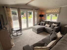 A living room with a sofa and coffee table at Berwick Holiday Park - Holiday Accommodation 37, Berwick-upon-Tweed