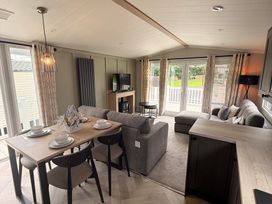 A living room with a sofa and dining table at Berwick Holiday Park - Holiday Accommodation 37, Berwick-upon-Tweed
