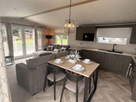 A living room and dining area with a sofa and table at Berwick Holiday Park - Holiday Accommodation 37, Berwick-upon-Tweed