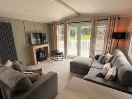 A living room with a television and sofa at Berwick Holiday Park - Holiday Accommodation 37 Berwick-upon-Tweed