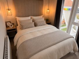 A bedroom with a bed and bedside table at Berwick Holiday Park - Holiday Accommodation 37 Berwick-upon-Tweed