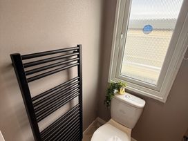 A bathroom with a toilet and towel radiator at Berwick Holiday Park - Holiday Accommodation 37 Berwick-upon-Tweed