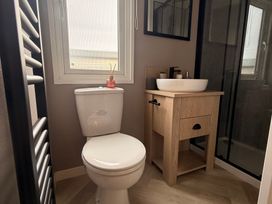 A bathroom with a toilet and sink at Berwick Holiday Park - Holiday Accommodation 37 Berwick-upon-Tweed