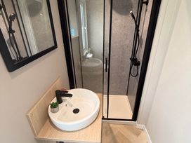 A bathroom with a sink and shower at Berwick Holiday Park - Holiday Accommodation 37 in Berwick-upon-Tweed