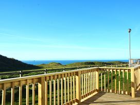 A deck overlooking the sea and hills at Perran Sands - Holiday Accommodation 4301 Perranporth