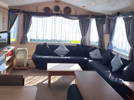 A living room with a sofa and coffee table at Towervans Holiday Park - Holiday Accommodation 5041, Mablethorpe