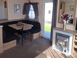 A dining area with a table and chairs at Towervans Holiday Park - Holiday Accommodation 5041, Mablethorpe