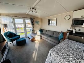 A living room with a sofa and armchair at Hopton Holiday Village - Holiday Accommodation 632 Great Yarmouth