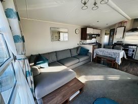 A living room with a sofa and dining table at Hopton Holiday Village - Holiday Accommodation 632 Great Yarmouth