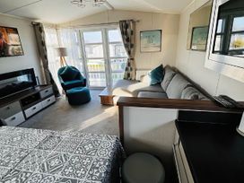 A living room with a sofa and television at Hopton Holiday Village - Holiday Accommodation 632 Great Yarmouth