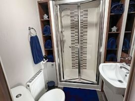 A bathroom with a shower, sink, and toilet at Hopton Holiday Village - Holiday Accommodation 632, Great Yarmouth