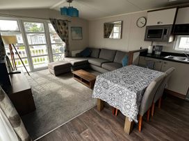 A living room with a sofa and dining table at Hopton Holiday Village - Holiday Accommodation 632, Great Yarmouth