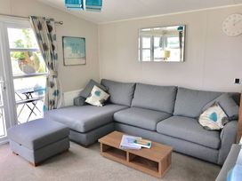 A living room with a sofa and coffee table at Hopton Holiday Village - Holiday Accommodation 632, Great Yarmouth