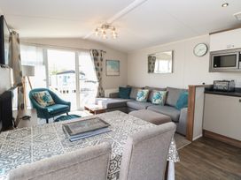 A living room with a sofa, table and chairs at Hopton Holiday Village - Holiday Accommodation 632 Hopton-On-Sea