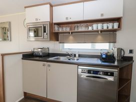 A kitchen with modern appliances at Hopton Holiday Village - Holiday Accommodation 632, Hopton-On-Sea