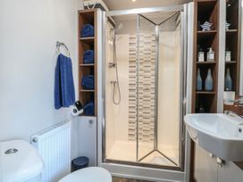 A bathroom with a shower, toilet, sink, and towels at Hopton Holiday Village - Holiday Accommodation 632 Hopton-On-Sea