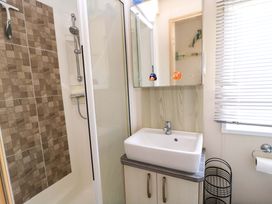 A bathroom with a shower and sink at Beachcombers in Wareham