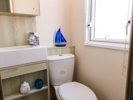 A bathroom with a sink and a toilet at Beachcombers in Wareham