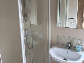 A bathroom with a shower and sink at Perran Sands - Holiday Accommodation 722 Perranporth