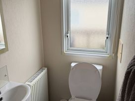 A bathroom with a toilet and sink at Perran Sands - Holiday Accommodation 722, Perranporth