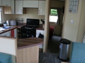 A kitchen with a gas stove and sink at Southview Holiday Park 7251 Skegness