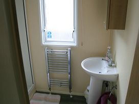 A bathroom with a sink and towel rail at Southview Holiday Park 7251 Skegness