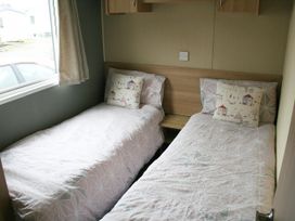 A bedroom with two single beds at Southview Holiday Park 7251 Skegness