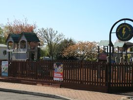A playground with a structure and signs at Southview Holiday Park 7251 Skegness