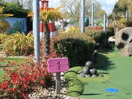 A mini golf course with a sign and landscaping at Southview Holiday Park 7251 Skegness