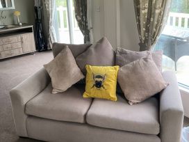 A sofa with cushions in a living room at White Acres Holiday Park - Holiday Accommodation 8002 Newquay