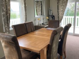 A dining room with a table and chairs at White Acres Holiday Park - Holiday Accommodation 8002, Newquay