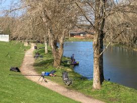 An outdoor fishing area along a river at White Acres Holiday Park - Holiday Accommodation 8002, Newquay