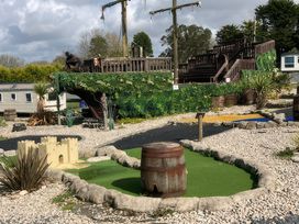 A mini golf area with a pirate ship and a castle at White Acres Holiday Park - Holiday Accommodation 8002 Newquay