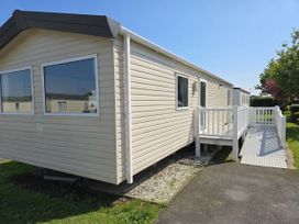 A mobile home with a deck and ramp at Golden Sands - Holiday Accommodation 8309 Mablethorpe