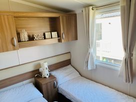 A bedroom with two beds and a window at Seashore Holiday Park - Holiday Accommodation 848 Great Yarmouth