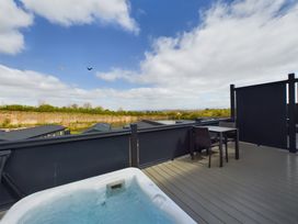 An outdoor area with a hot tub and table at Coniston in Penrith