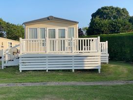 A holiday home with a deck and steps at White Acres Holiday Park - Holiday Accommodation 895, Newquay