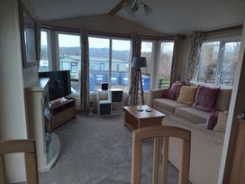 A snug area with a sofa and television at Aberystwyth Holiday Village - Holiday Accommodation 9213 Aberystwyth