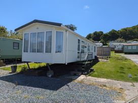 A mobile home with steps and planting bed at Aberystwyth Holiday Village - Holiday Accommodation 9213 Aberystwyth