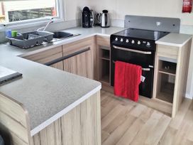 A kitchen with a sink and an oven at Beverley Bay Holiday Park - Holiday Accommodation 9506, Paignton